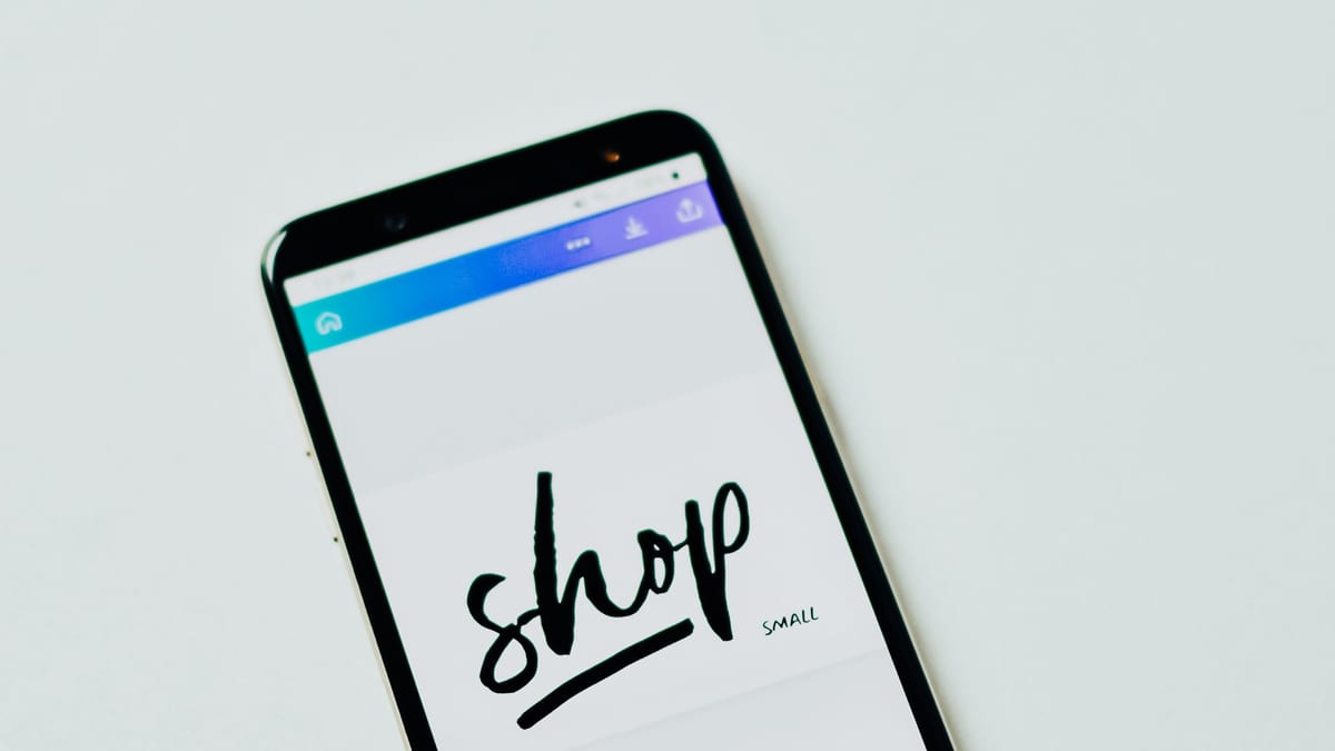 A smartphone showing an online shop screen, lying on a white surface